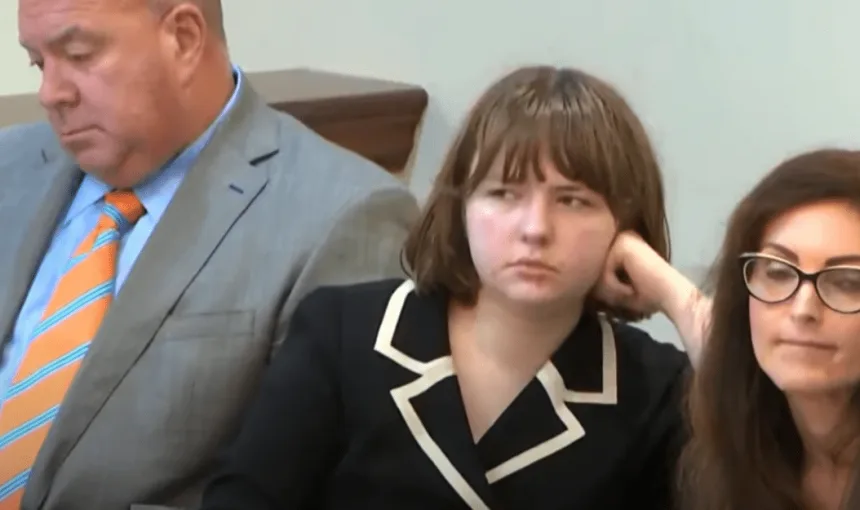 Carly in court wearing a black blazer with white trim