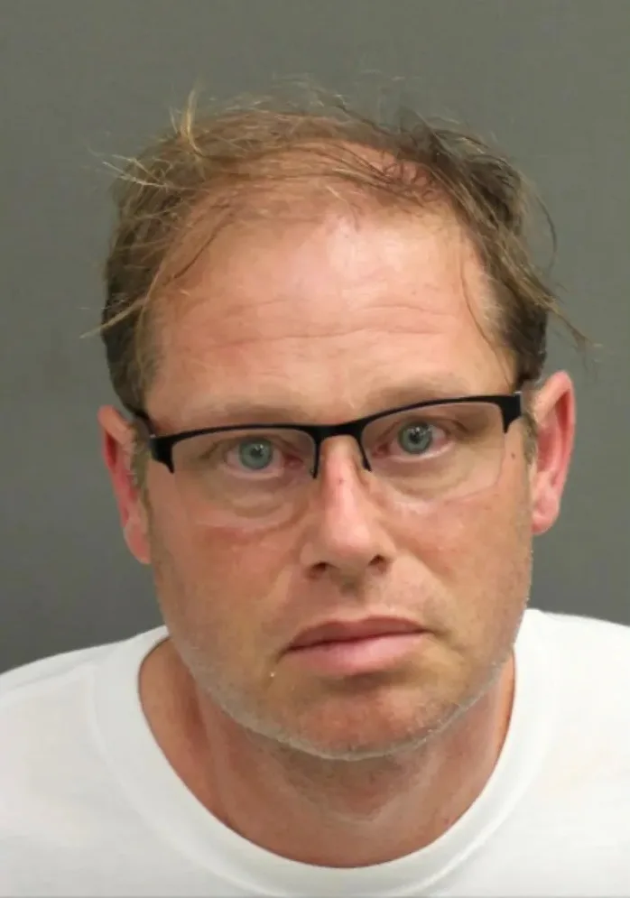 Man in white tshirt with glasses on