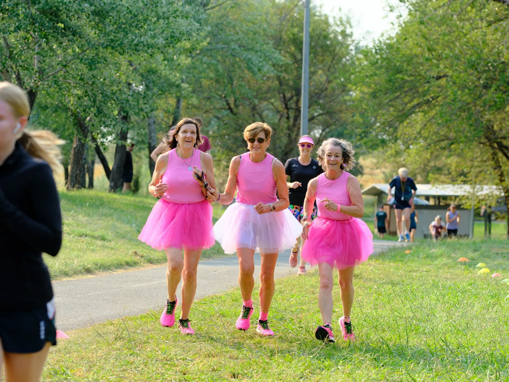 women running together in tutus