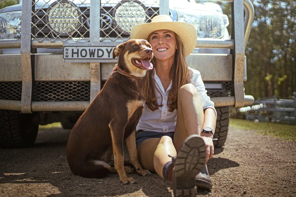 Image of country woman sitting with kelpie dog