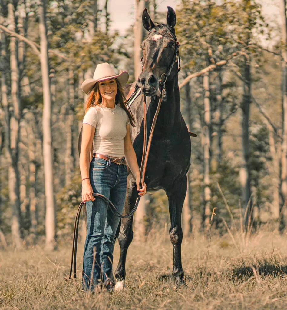 Image of country woman standing with brown horse