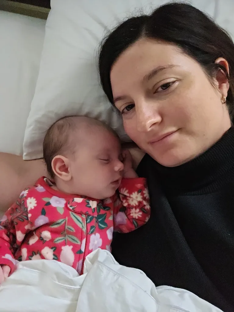 Woman with baby in pink and white spotted top