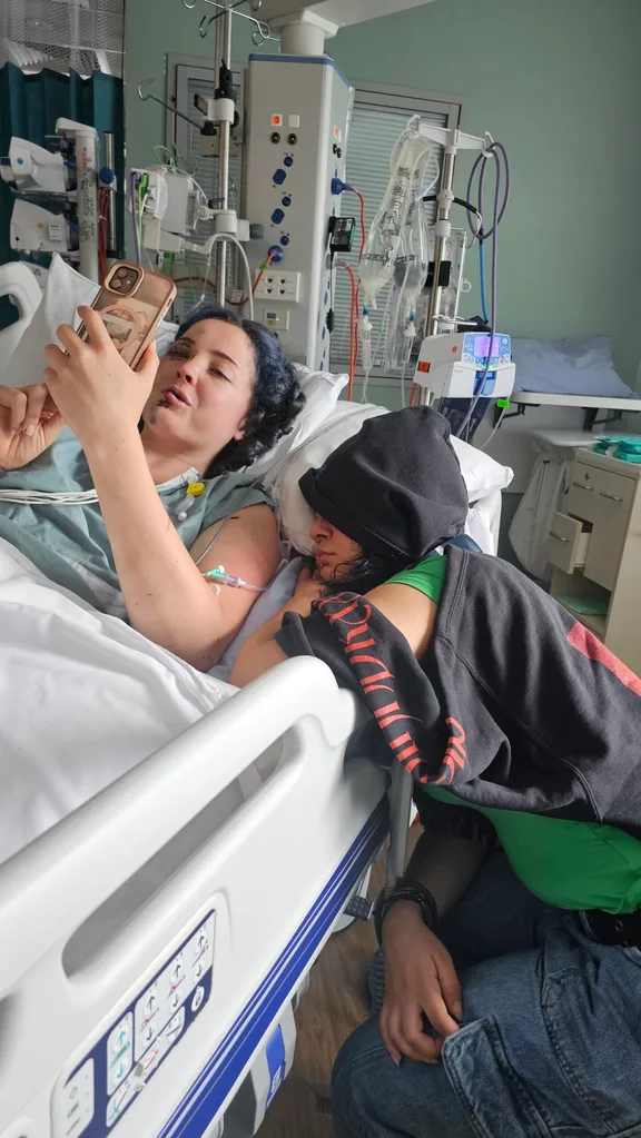 Image of woman recovering in hospital with a visitor friend