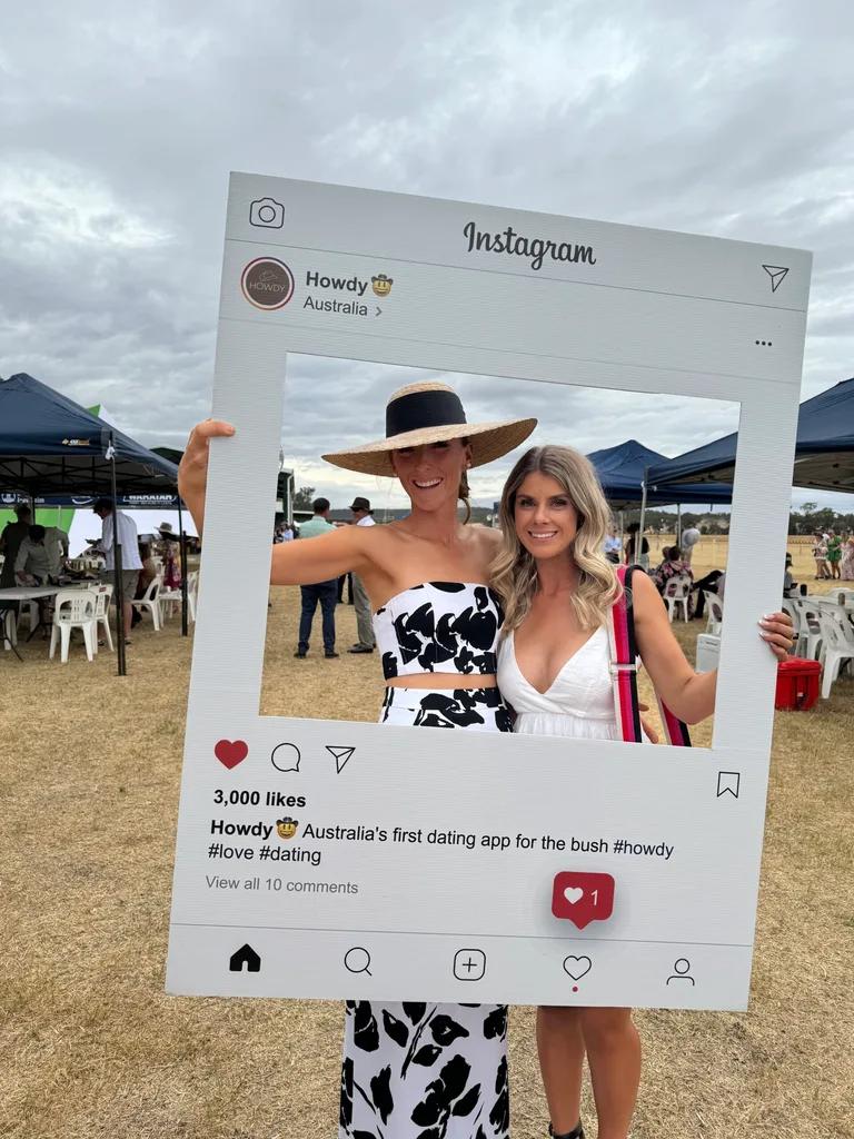Image of two women standing with cardboard cut out