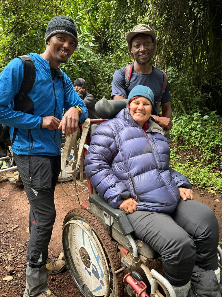 Image of porter guide standing with woman sitting in wheelchair