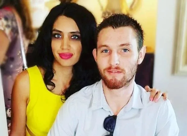 women in yellow top with black hair and man in white shirt with sunglasses