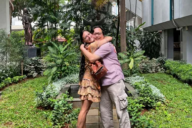 Missy in Jakarta. She is hugging with a man as they both smile at the camera.