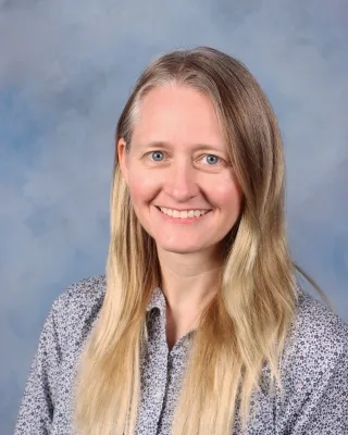 Heather wearing a grey business shirt