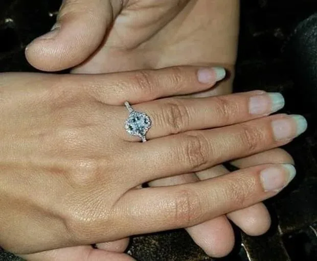 woman;s hand with diamond engagement ring 