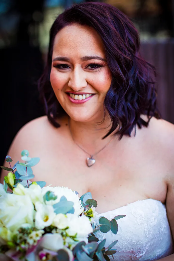 Ebony wearing her bridal makeup and wearing her wedding dress.