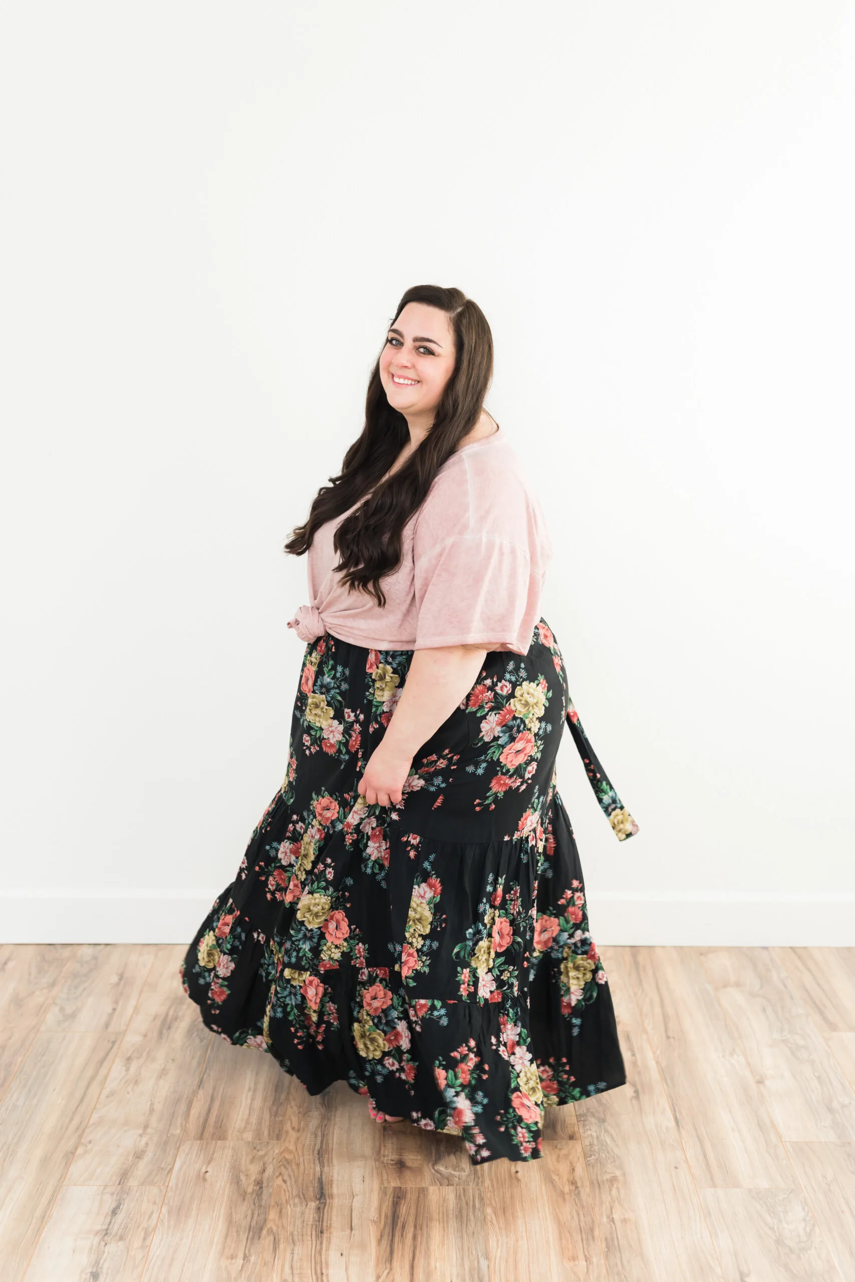 woman in black dress with flowers and pink top