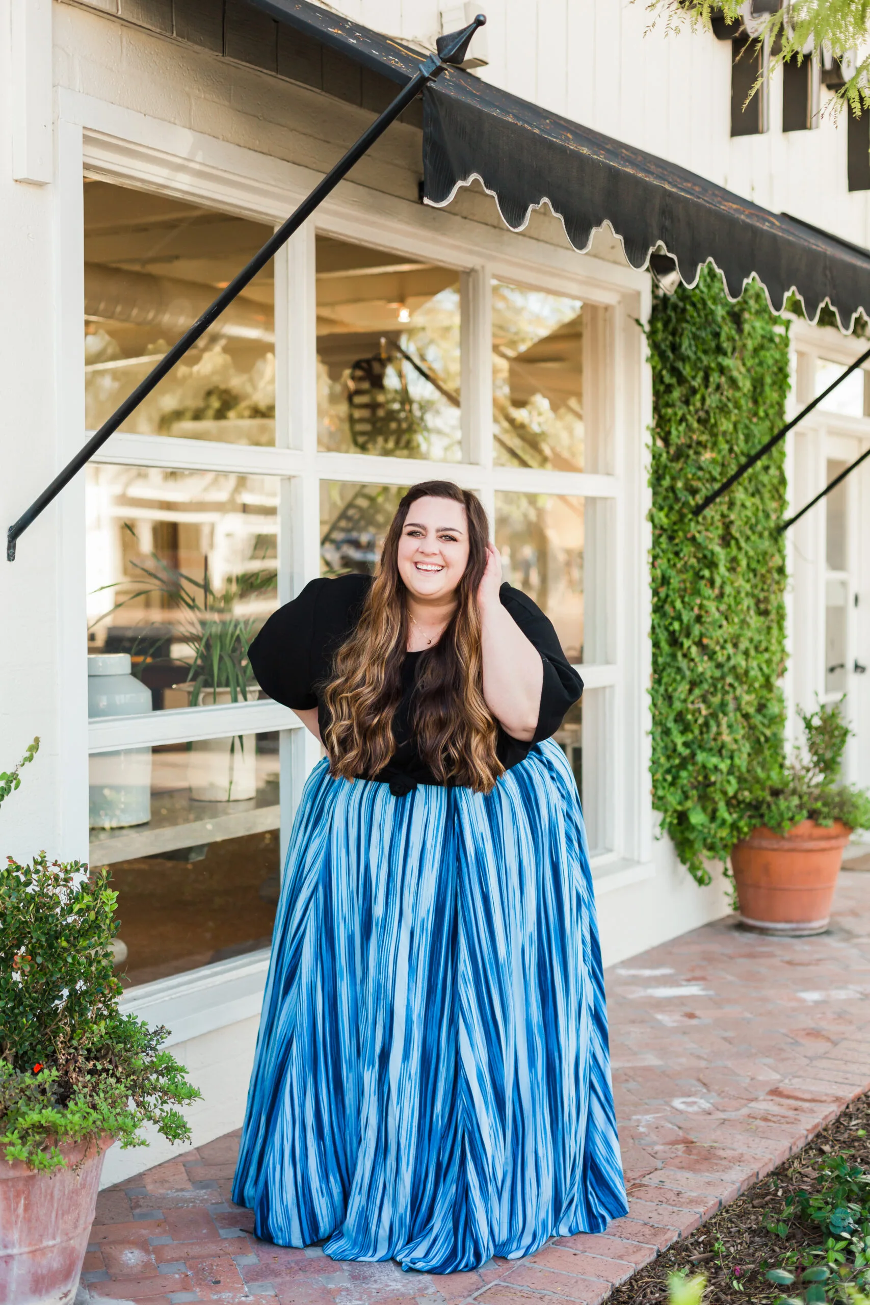 woman in blue skirt and black top