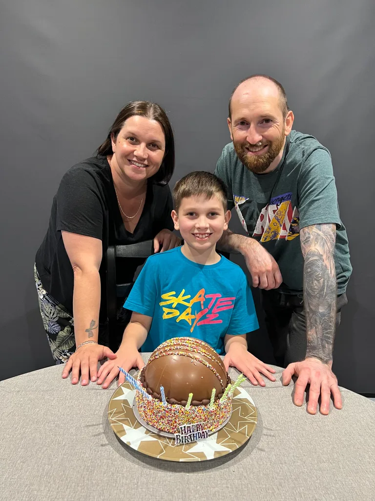 Image of mum, dad and son on his birthday