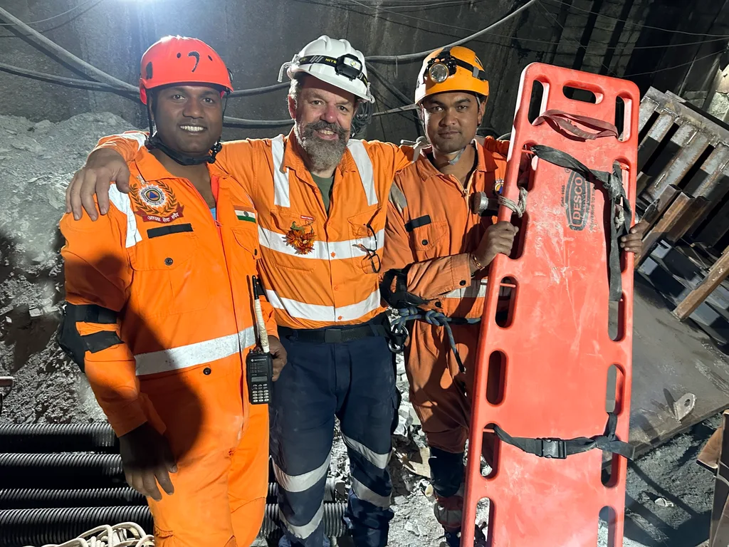 Image of three men in mine rescue