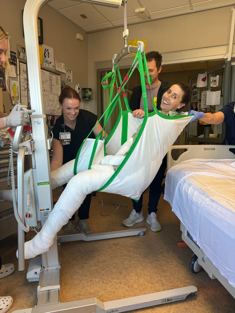 Image of woman being moved while in hospital recovering from septic shock