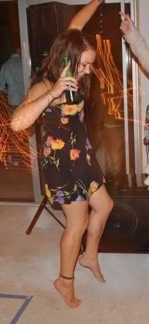 Younger Libby drinking at a party. 