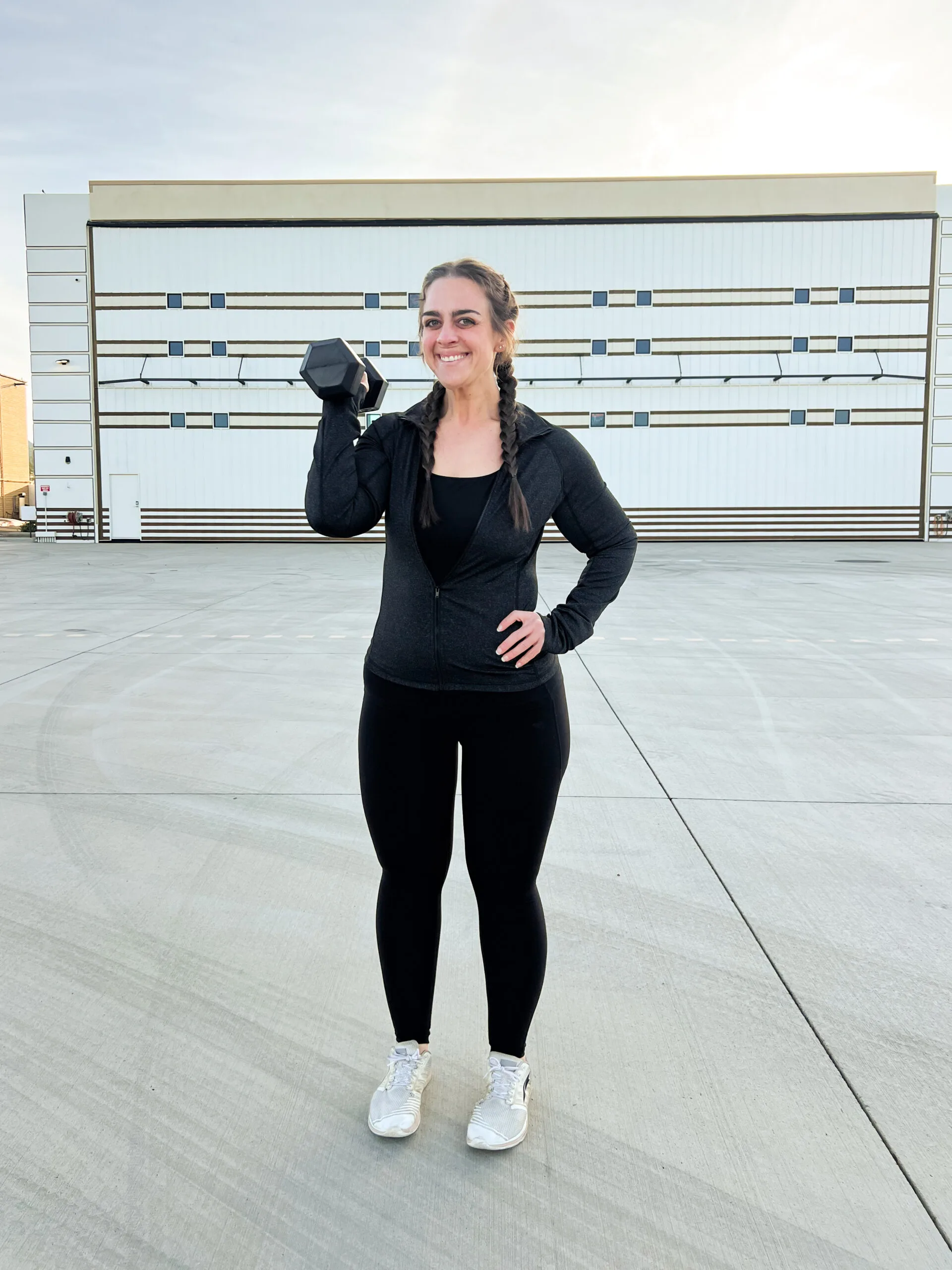 woman in black holding a weight