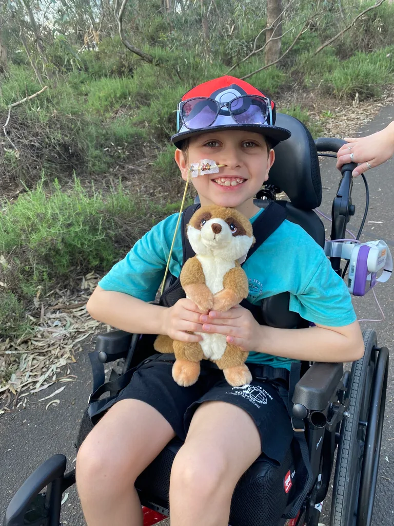 Image of young boy sitting in a wheelchair