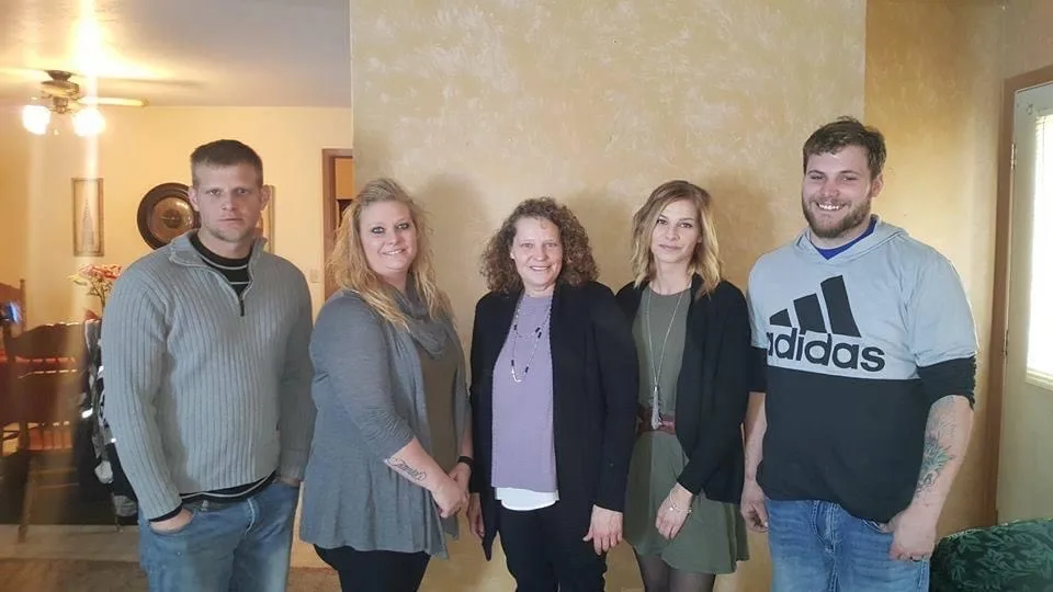 Donor Jill with her family. They are standing side by side and looking at the camera.