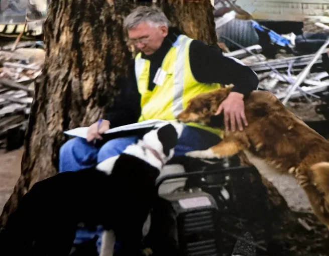 Man sitting with two dogs