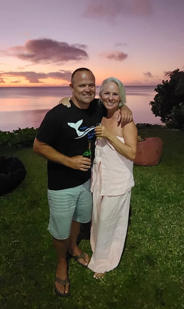 Carmen Ellis and her husband Matt in Tonga. They are hugging and smiling.