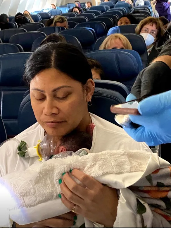 woman holding baby on plane