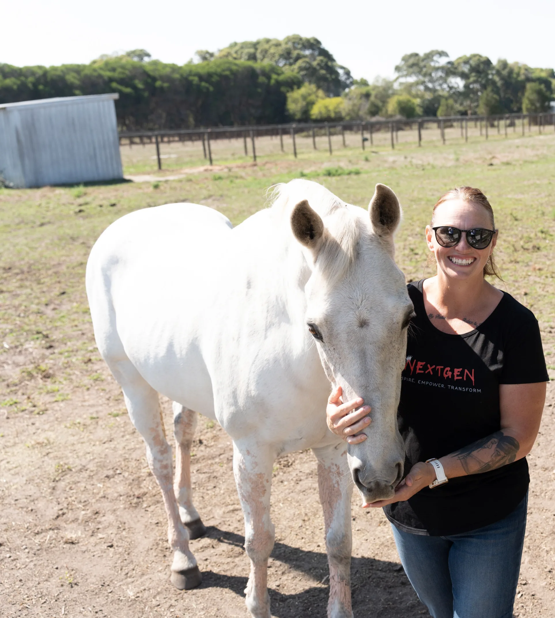 white horse and woman standing together