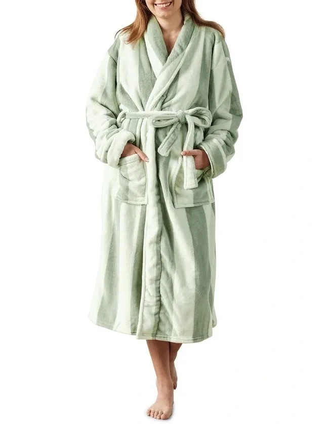 woman against white background wearing a green robe
