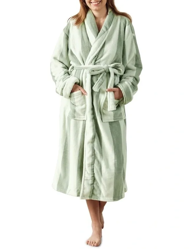 woman against white background wearing a green robe