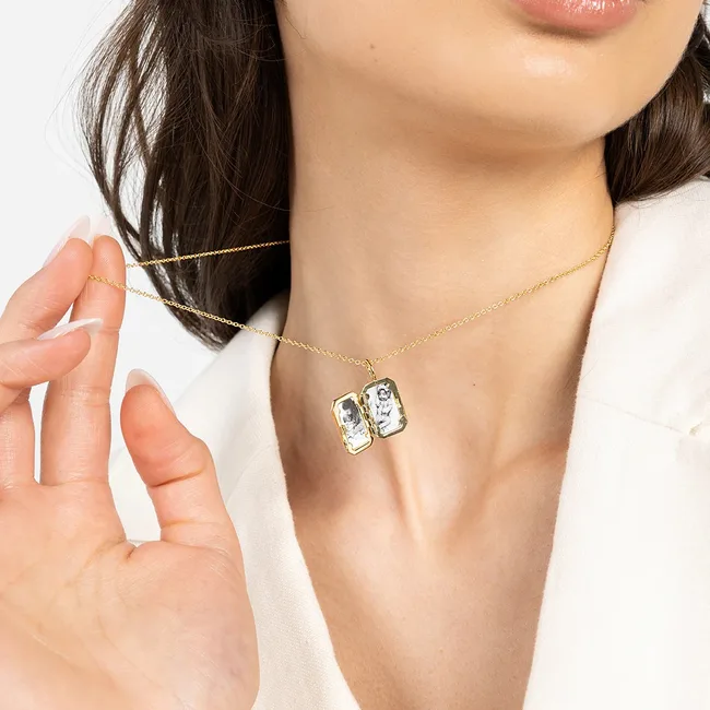 Woman holding a personalised locket necklace in silver