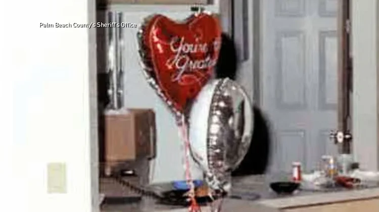 red heart balloon and silver foil balloon on doorstep