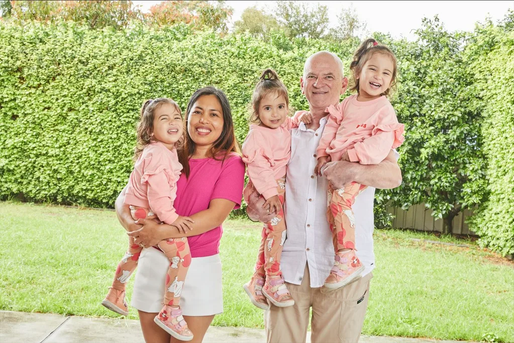 Image of mum and dad with triplet daughters