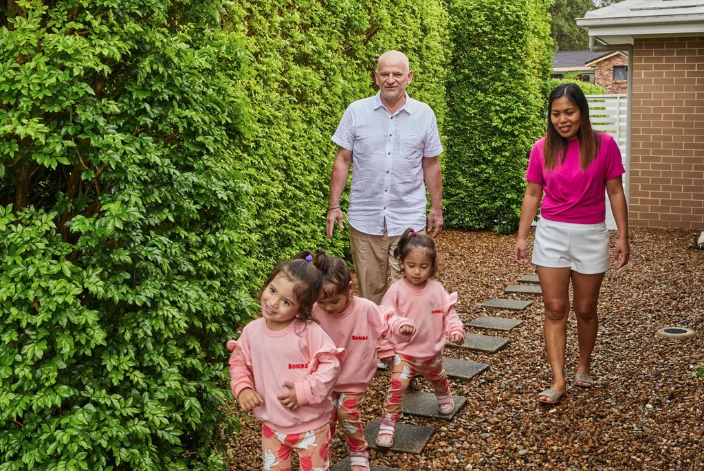 Image of triplets walking in a row