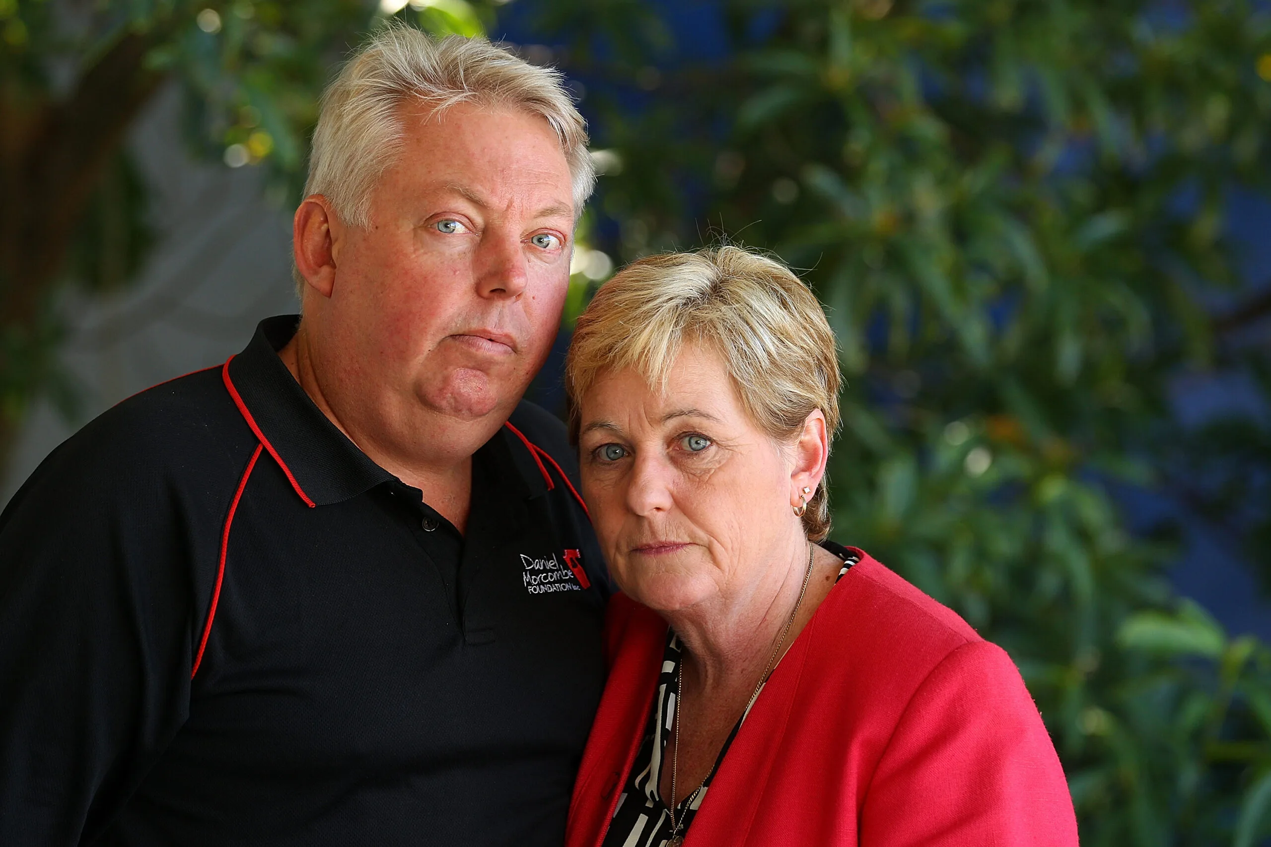 man in dark top and woman in red top