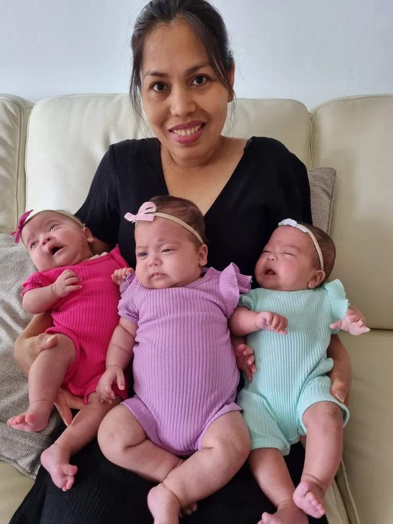 Image of mum holding triplet girls