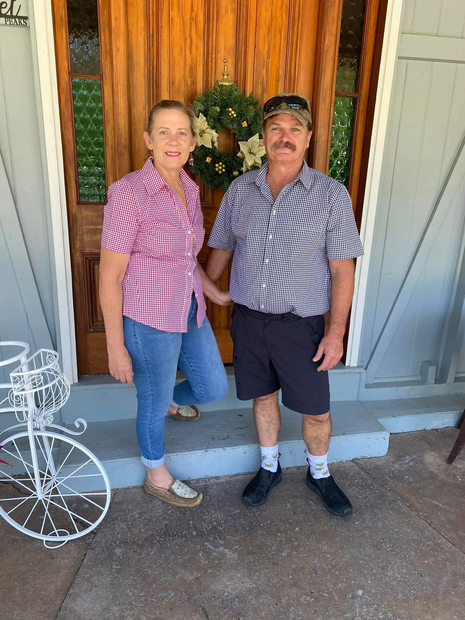 woman in pink shirt and jeans with man withblack and white top and black shorts