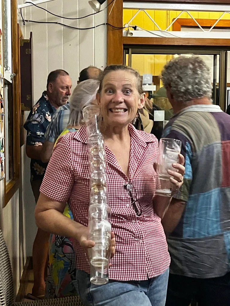 woman holding glasses in a pub