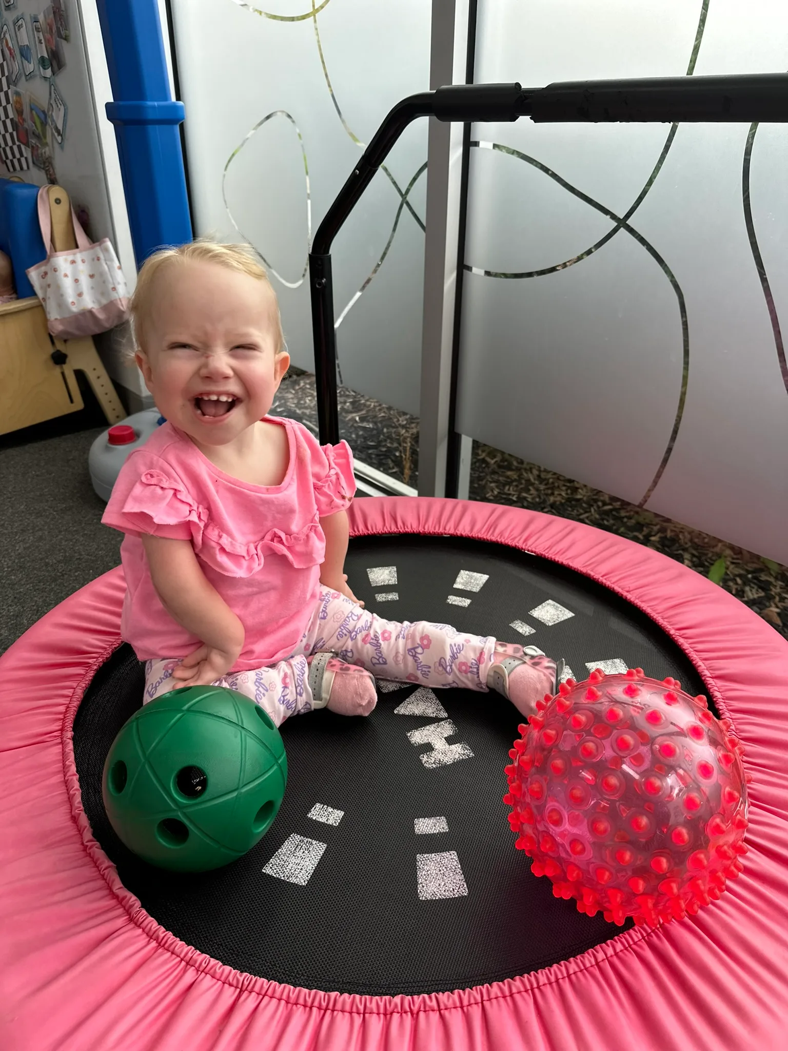Image of young girl sitting on trampoline
