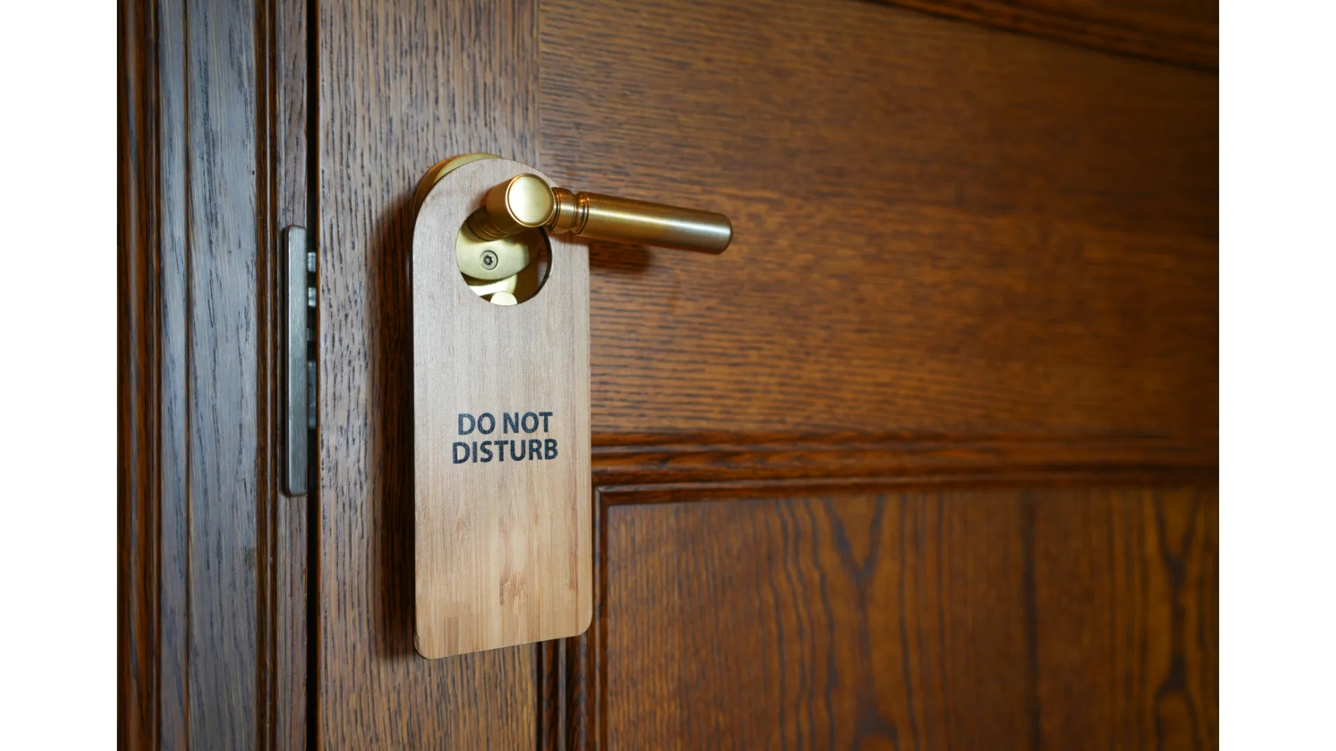 A 'Do Not Disturb' sign hangs on a door handle.