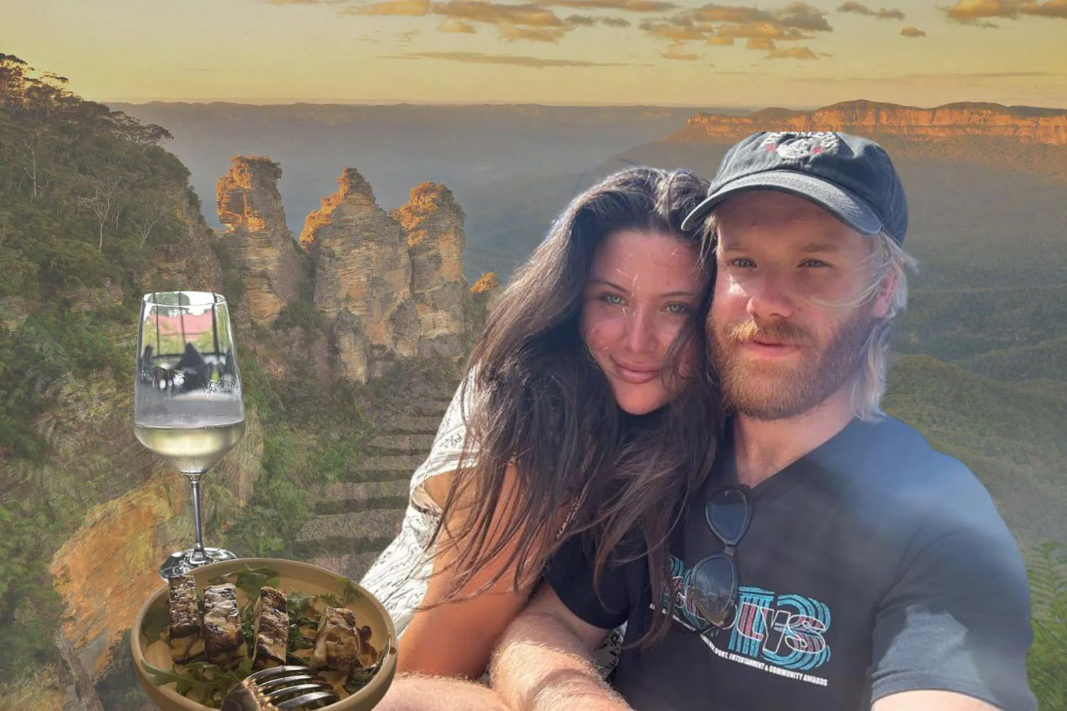 A couple (man and woman) against a backdrop of the Blue Mountains (two visuals overlapping - one of the Three Sisters and the other is a walking track). Next to them on the left is a glass of white wine and a plate of halloumi.