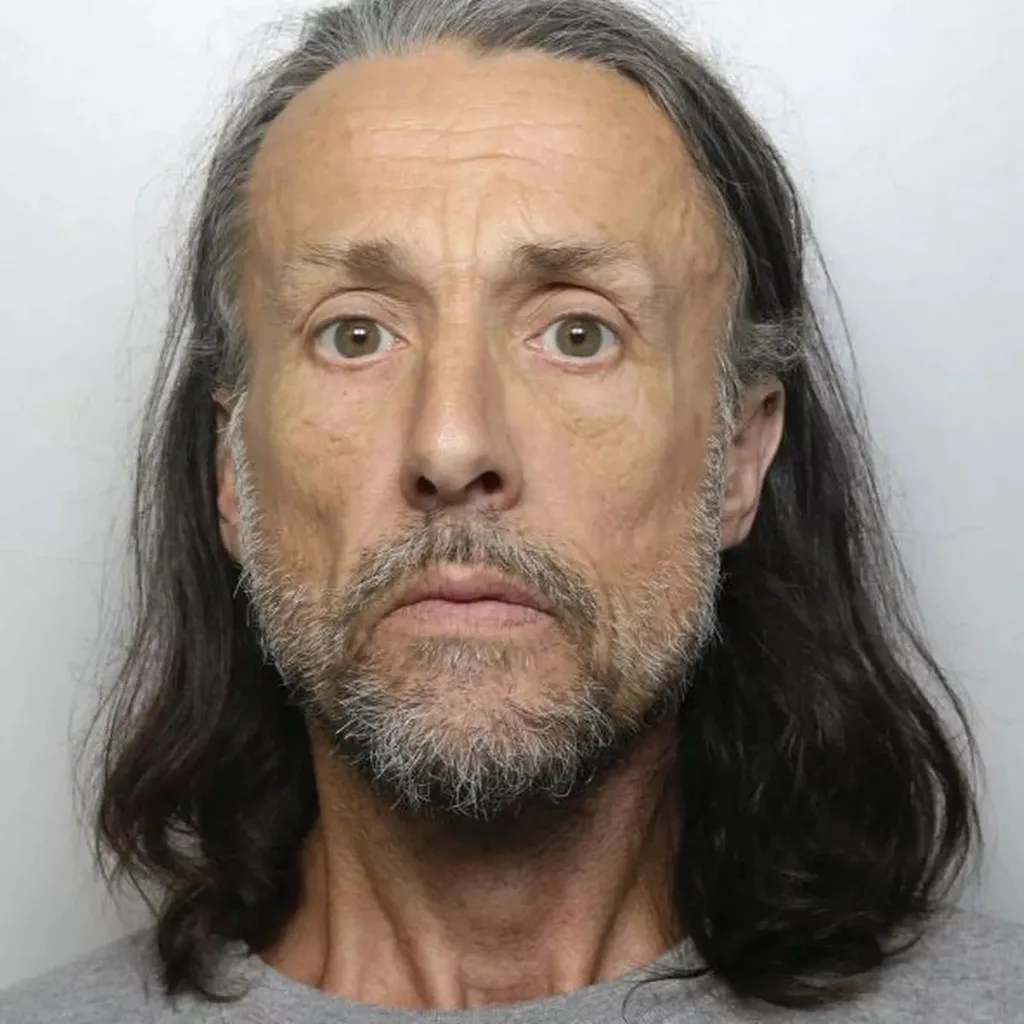 Man with long grey hair and beard