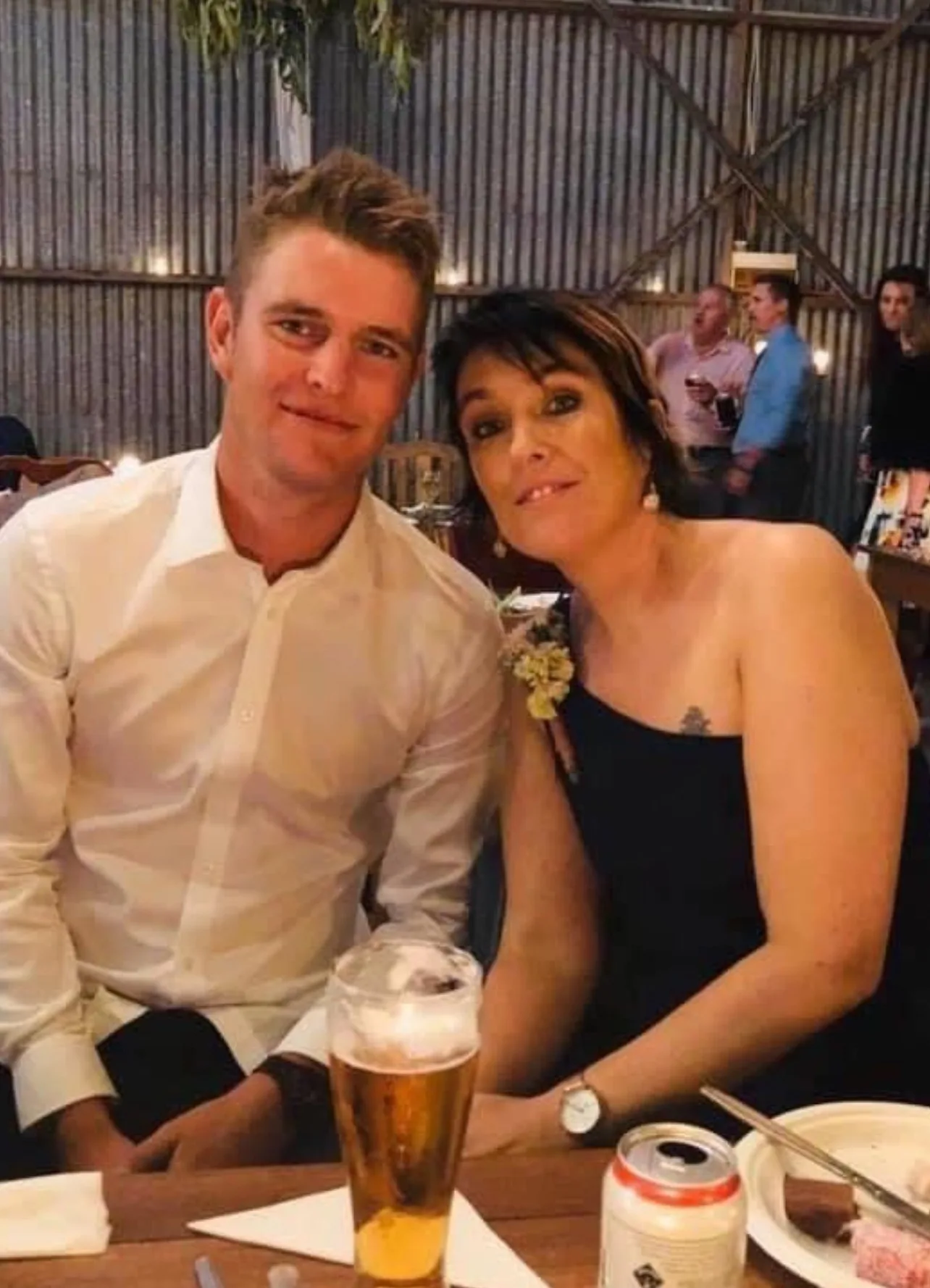 man in white shirt and woman in one shoulder black dresss