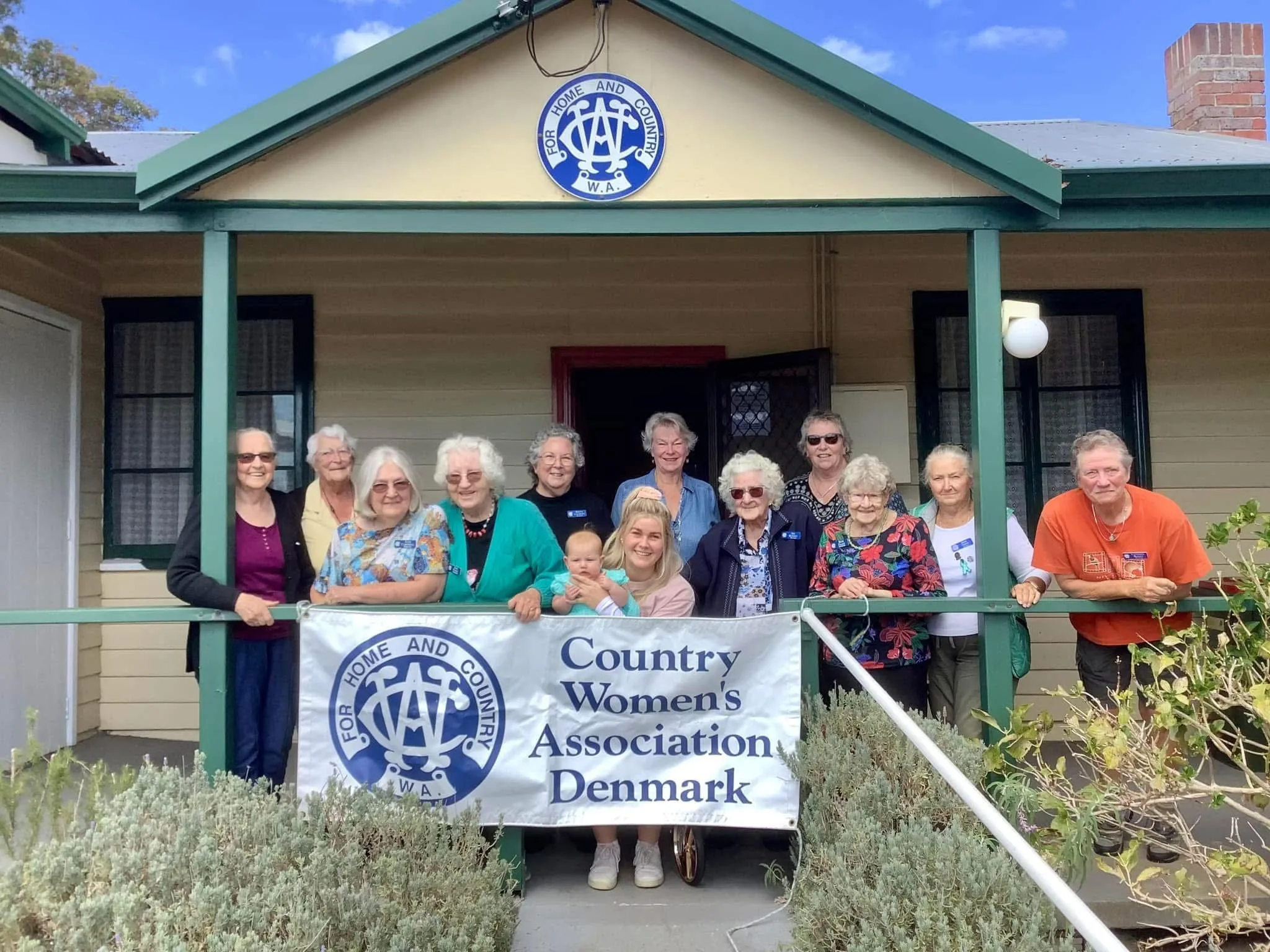 Image of women smiling standing at their local Country Womens Association Denmark