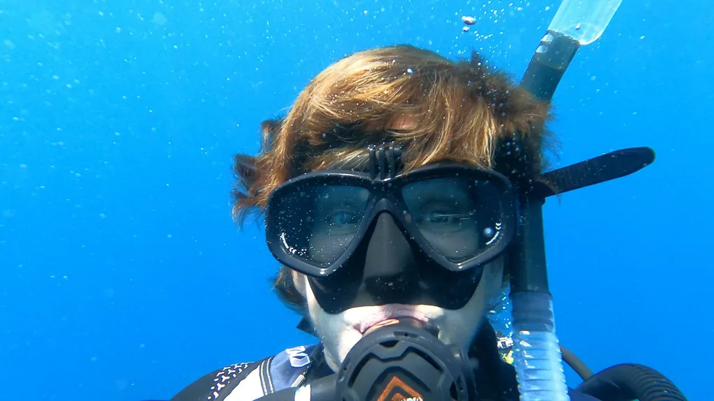Image of woman underwater wearing scuba diving mask