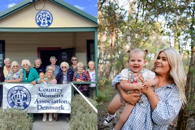 Image of women smiling standing at their local Country Womens Association Denmark and mum wearing blue and white dress and holding baby wearing floral onesie