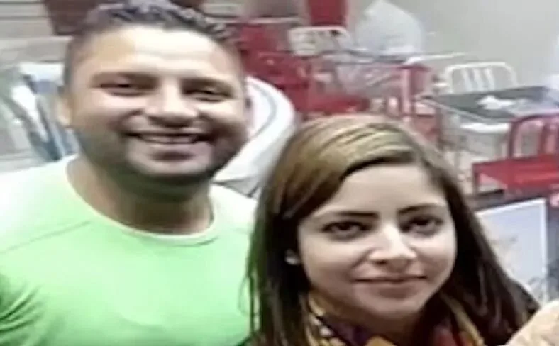 man in green shirt with woman taking selfie
