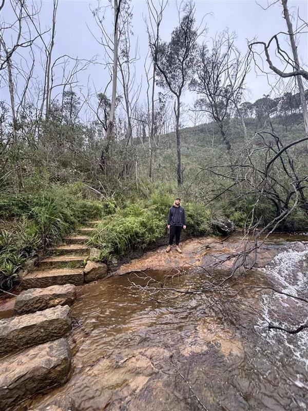 A man standing in the distance at Pope Glen track