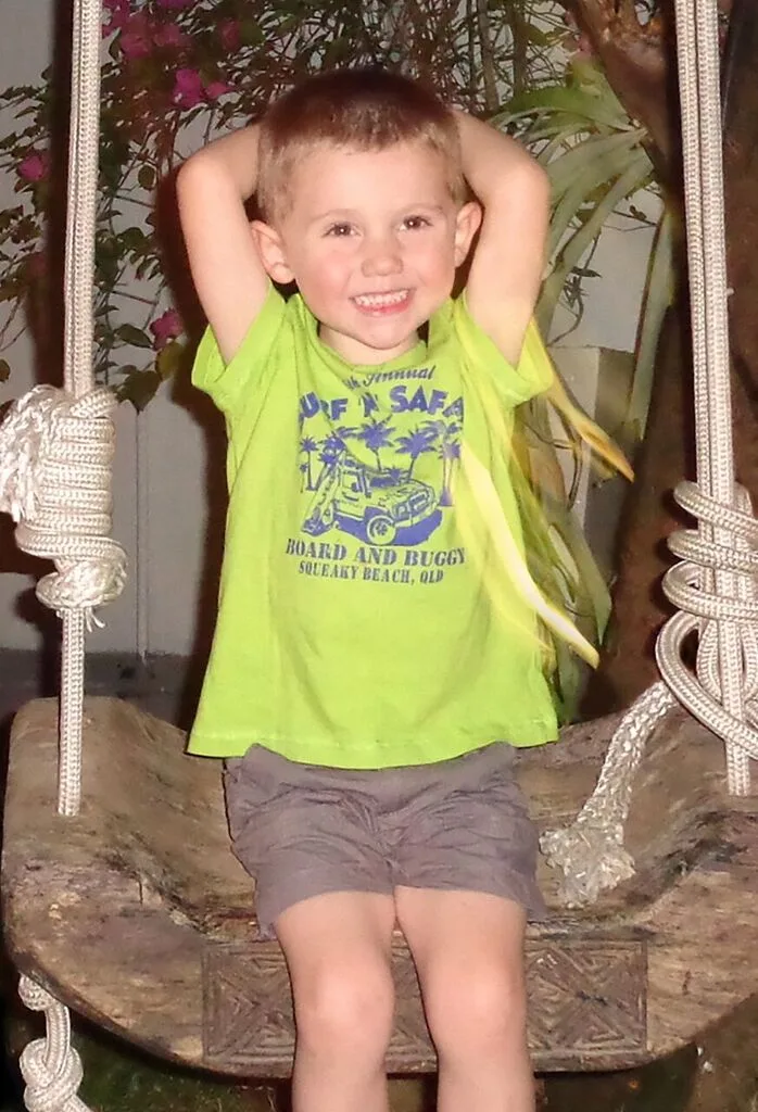 William Tyrrell wearing a bright green shirt and smiling.