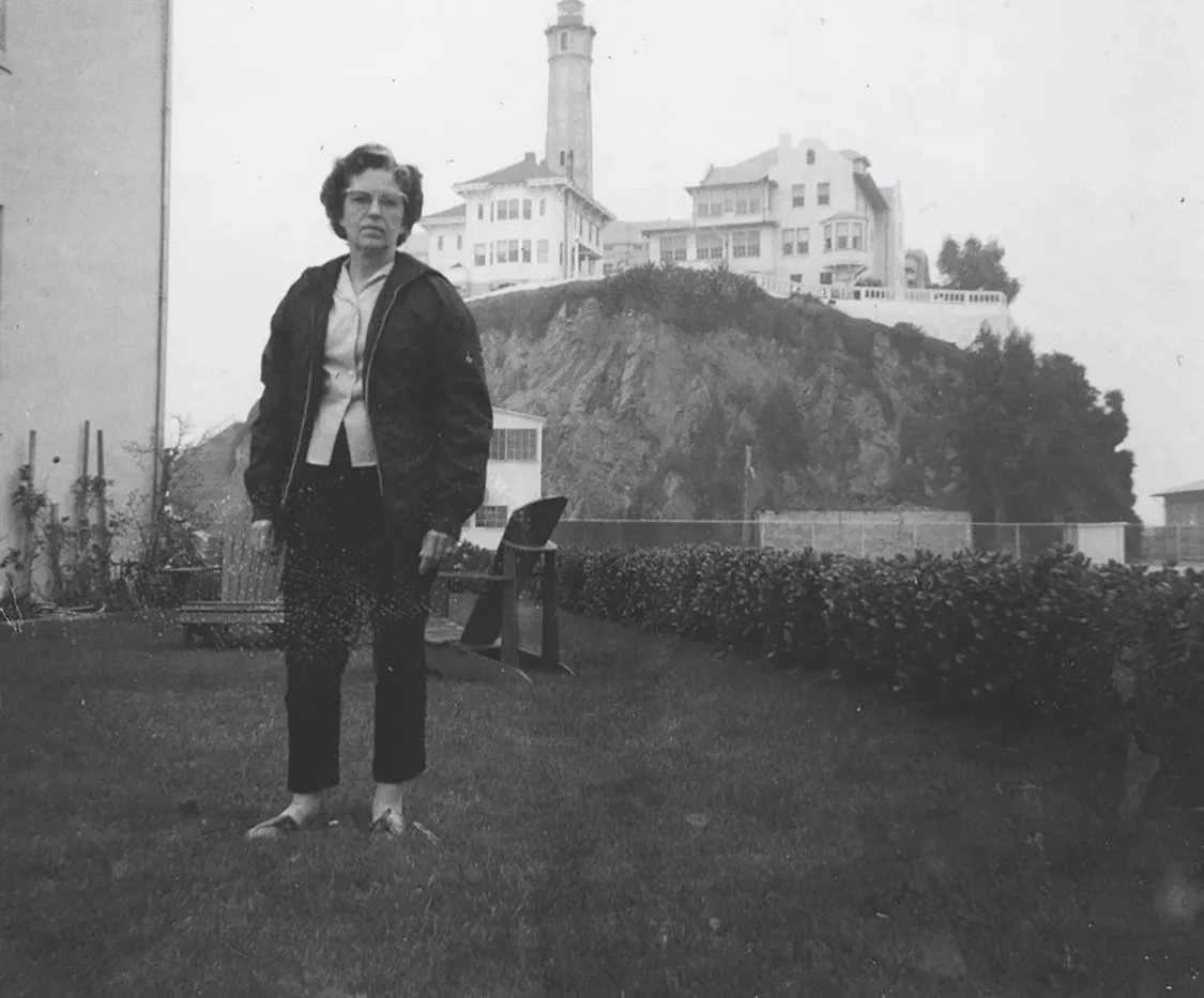 BLACK AND WHITE PHOTO OF WOMAN IN FRONT OF ALCATRAZ