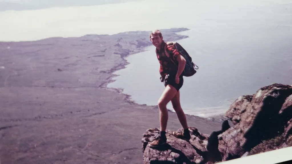 An old photograph of a young Bob hiking
